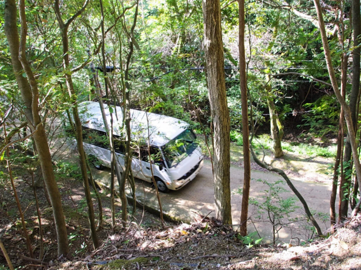 A minibus running on a special road. Photographed from the pilgrimage route. 