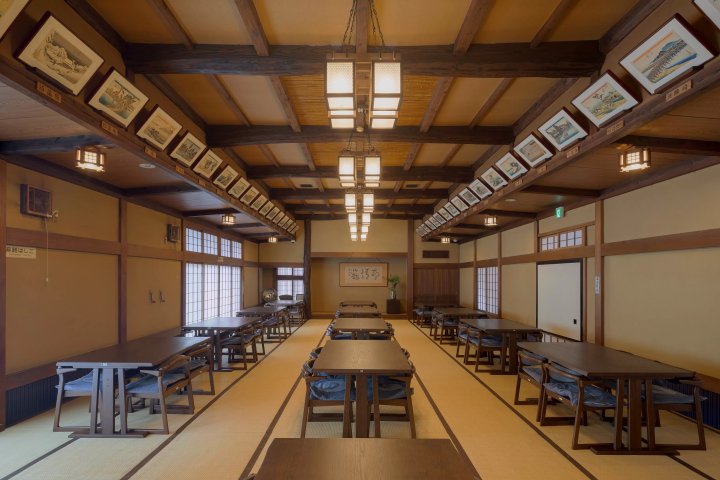 A tatami room with table seating, decorated with furnishings and ukiyo-e art reminiscent of the Edo period 