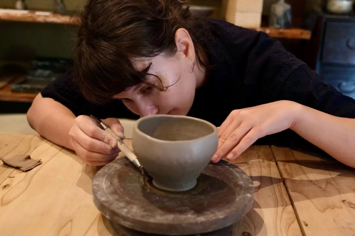 Kristina is crafting her large coffee cup during a hands-on Awaji-Iga ware workshop with Maeda-san