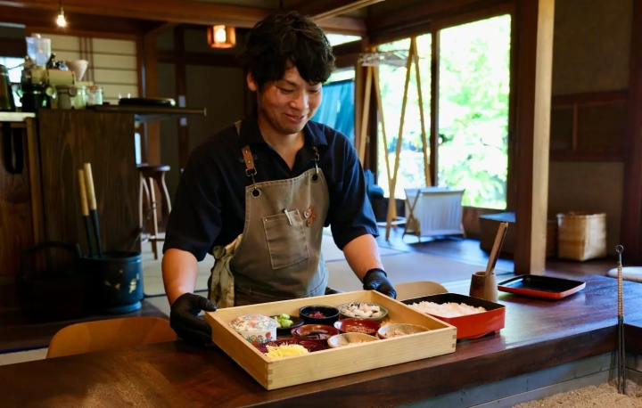 Michiru Okano, owner-chef of KAIRI, serving a meal made with local seasonal ingredients on Awaji pottery
