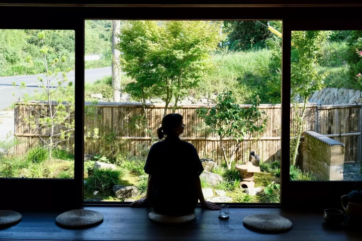 Kristina sitting at KAIRI, enjoying the warm light in the garden